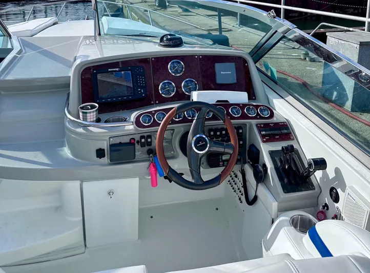  Yacht Photos Pics 2004 Formula 370 Super Sport boat cockpit with steering wheel and navigation instruments.