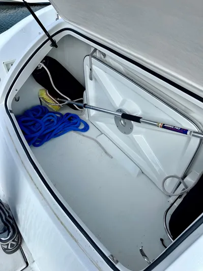  Yacht Photos Pics Open storage compartment on 2004 Formula 370 Super Sport boat with rope and cleaning tools.