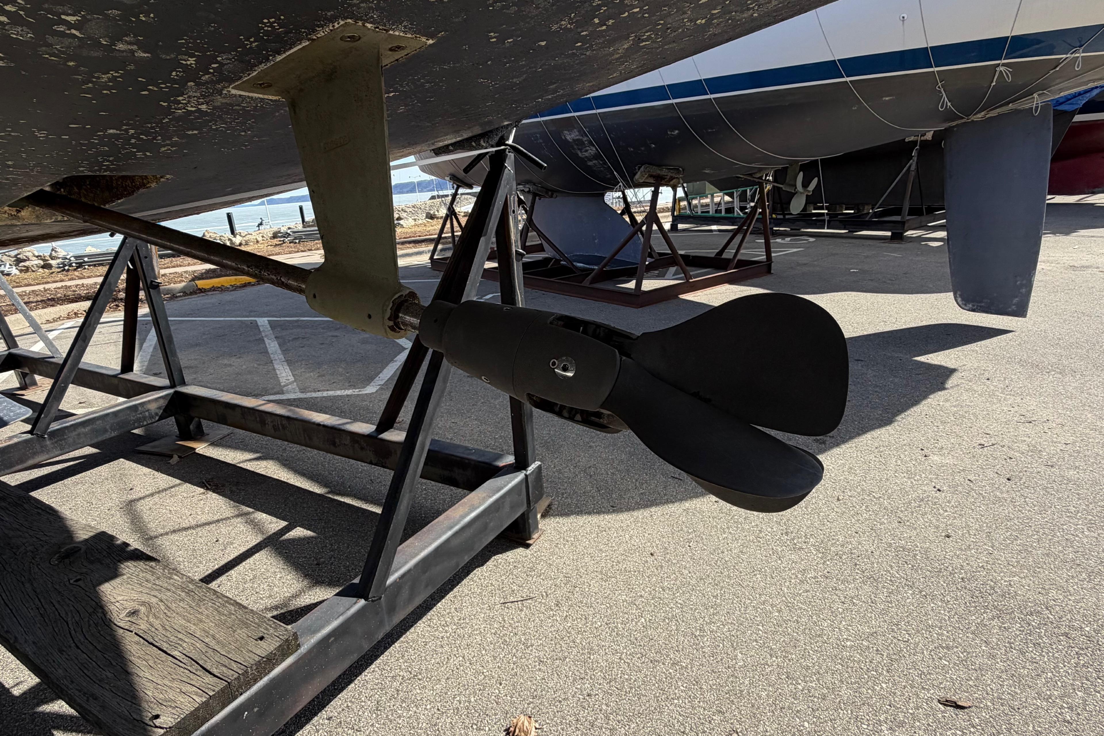 Propeller of a 2005 Hunter 38 sailboat on a stand in a boatyard.