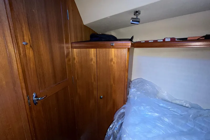 Nauti Cat Yacht Photos Pics Interior cabin of 2005 Hunter 38 sailboat with wooden cabinetry and bedding.