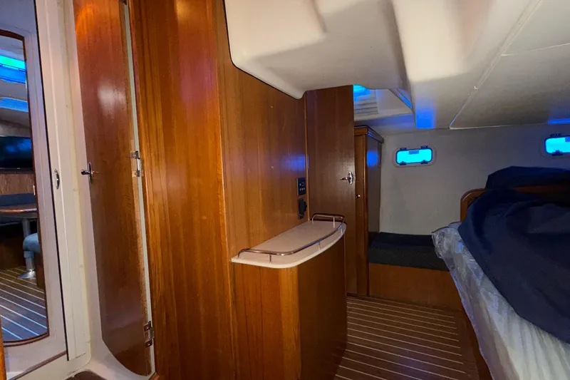 Nauti Cat Yacht Photos Pics 2005 Hunter 38 yacht interior with wooden paneling and cozy sleeping area.