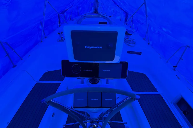 Nauti Cat Yacht Photos Pics Steering area of a 2005 Hunter 38 sailboat, illuminated in blue light.