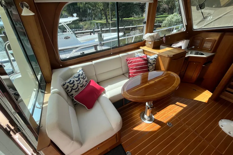 Sundog Yacht Photos Pics Interior of 2012 Sabre 42 Salon Express with cozy seating and wooden table.