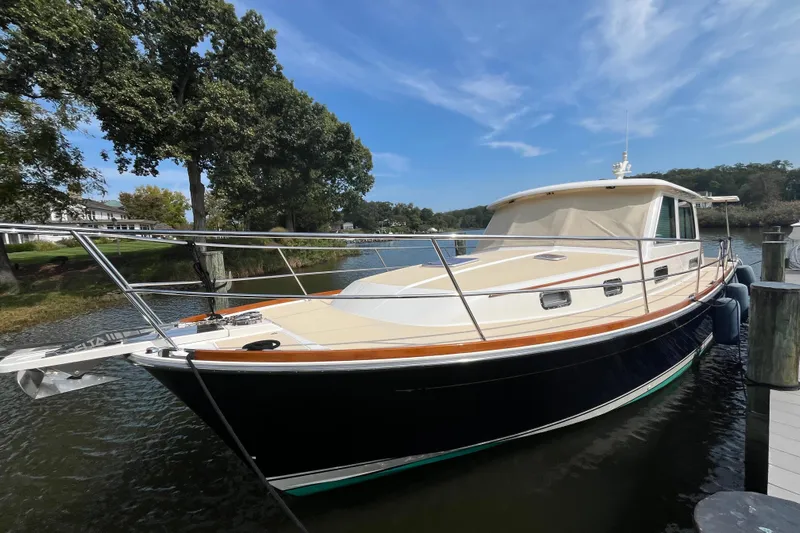 Sundog Yacht Photos Pics 2012 Sabre 42 Salon Express yacht docked by a scenic waterfront.