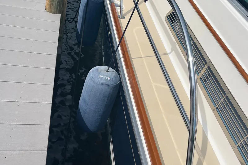 Sundog Yacht Photos Pics 2012 Sabre 42 Salon Express docked with fenders, showcasing sleek design and polished railings.