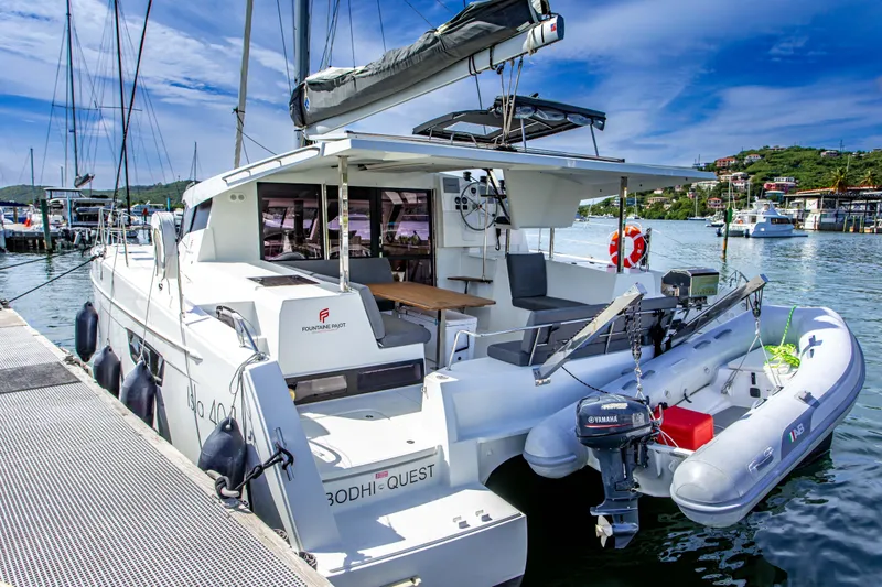 Bodhi Quest Yacht Photos Pics 2023 Fountaine Pajot Isla 40 catamaran docked at marina, featuring spacious deck and modern design.