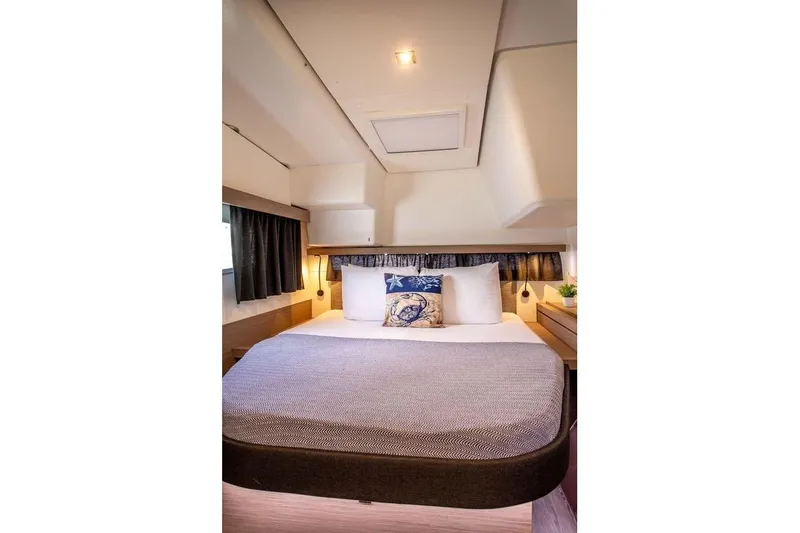 Bodhi Quest Yacht Photos Pics Luxurious cabin interior of 2023 Fountaine Pajot Isla 40 catamaran, featuring a cozy bed.