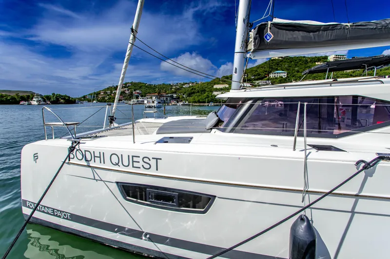 Bodhi Quest Yacht Photos Pics 2023 Fountaine Pajot Isla 40 catamaran docked in a scenic marina.