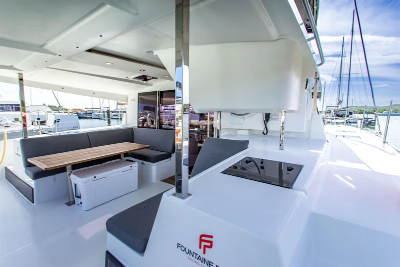 Bodhi Quest Yacht Photos Pics 2023 Fountaine Pajot Isla 40 catamaran deck with seating and dining area.