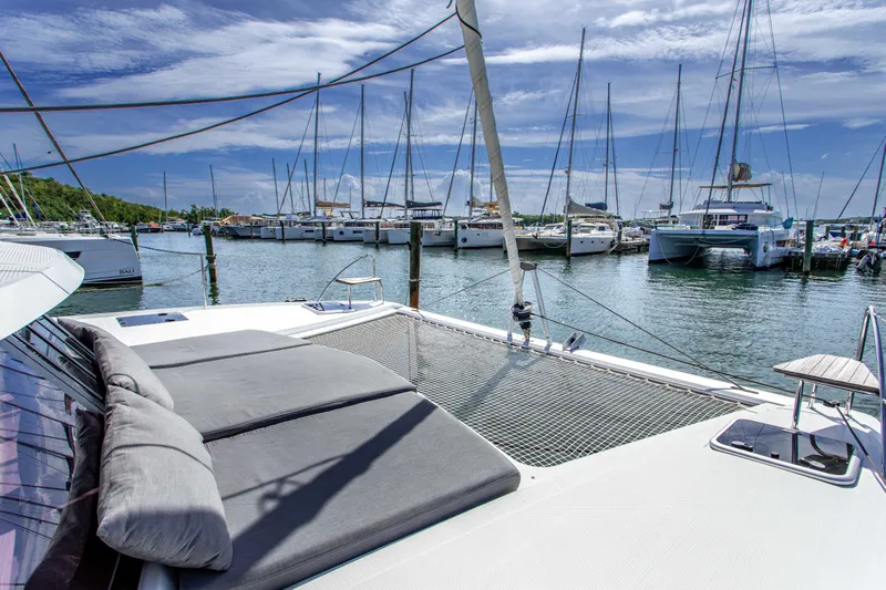 Bodhi Quest Yacht Photos Pics 2023 Fountaine Pajot Isla 40 catamaran docked in a marina under a clear blue sky.