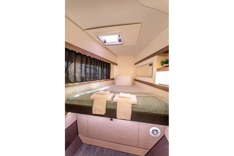 Bodhi Quest Yacht Photos Pics Cozy cabin interior of 2023 Fountaine Pajot Isla 40 catamaran with bed and skylight.