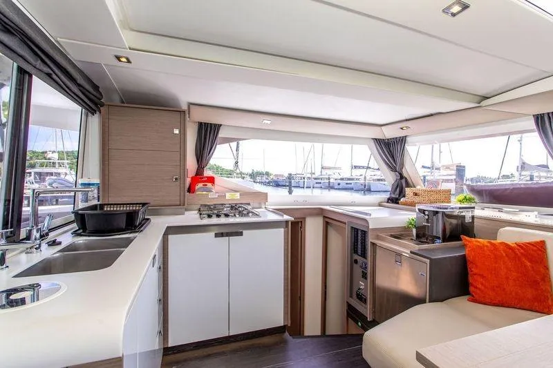 Bodhi Quest Yacht Photos Pics Interior of 2023 Fountaine Pajot Isla 40 catamaran with modern kitchen and seating area.