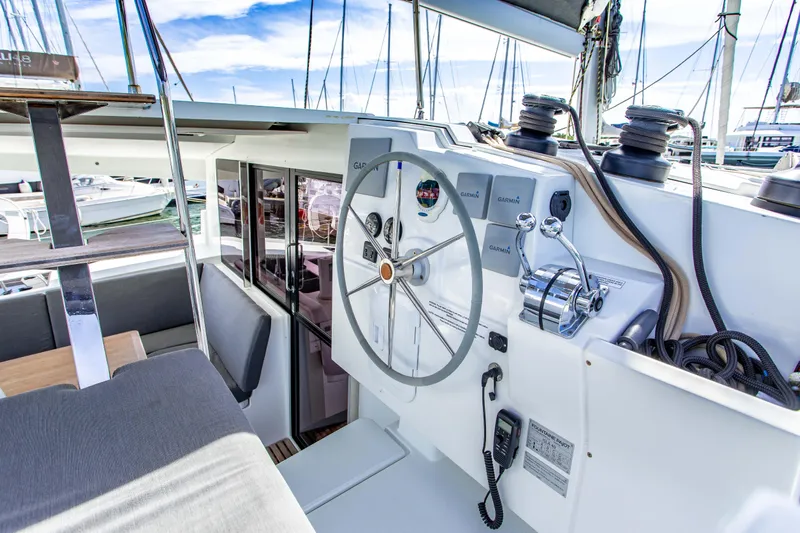 Bodhi Quest Yacht Photos Pics 2023 Fountaine Pajot Isla 40 yacht helm with modern navigation equipment and seating area.