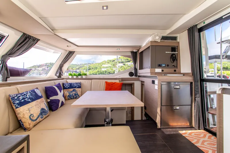 Bodhi Quest Yacht Photos Pics Luxurious interior of 2023 Fountaine Pajot Isla 40 catamaran with modern seating and decor.
