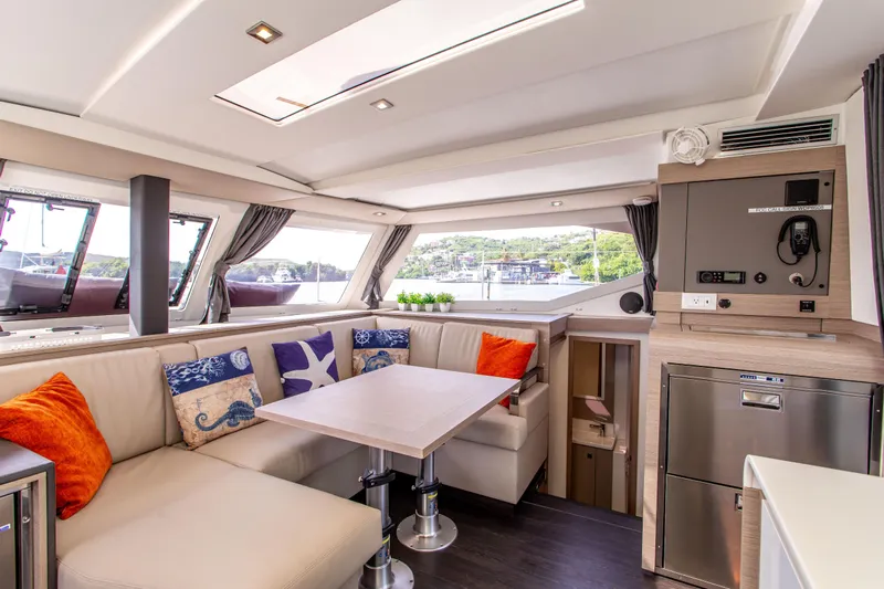 Bodhi Quest Yacht Photos Pics Luxurious interior of 2023 Fountaine Pajot Isla 40 catamaran with modern seating and decor.