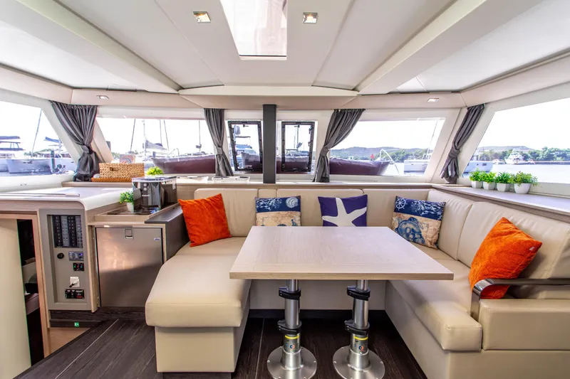 Bodhi Quest Yacht Photos Pics Luxurious interior of 2023 Fountaine Pajot Isla 40 catamaran with elegant seating and decor.
