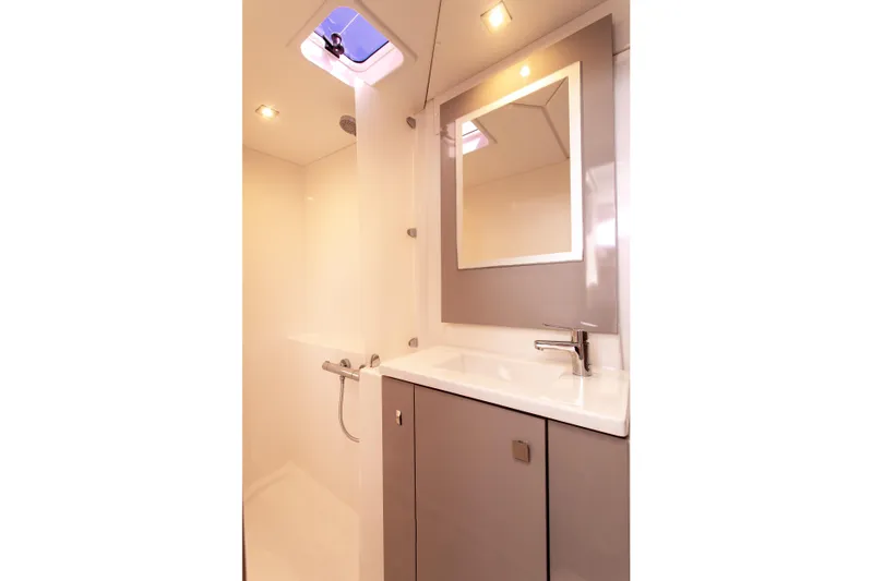 Bodhi Quest Yacht Photos Pics Modern bathroom interior of 2023 Fountaine Pajot Isla 40 catamaran, featuring sleek design and fixtures.
