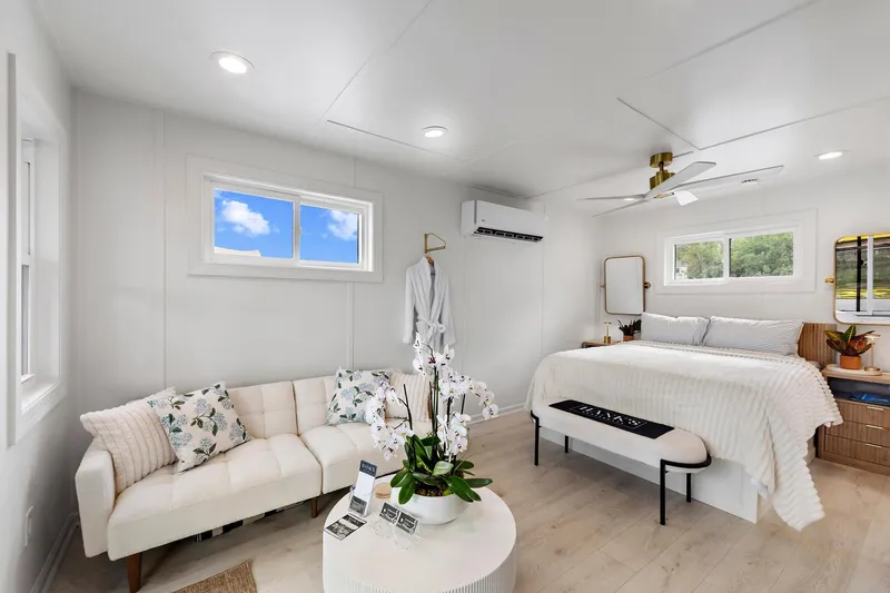  Yacht Photos Pics Modern interior of 2026 Custom Hanks 26 Houseboat with cozy bed and stylish decor.