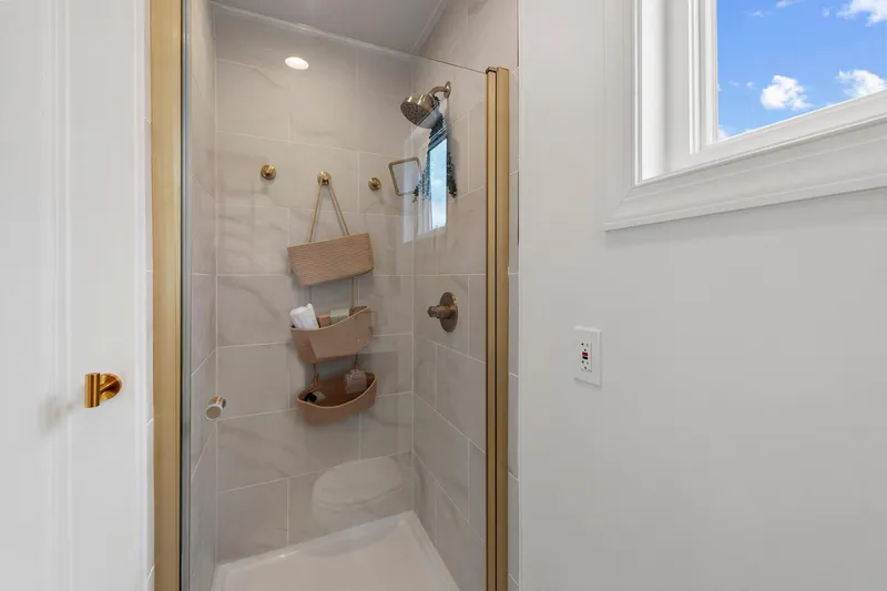  Yacht Photos Pics Modern shower in 2026 Custom Hanks 26 Houseboat with elegant fixtures and natural light.