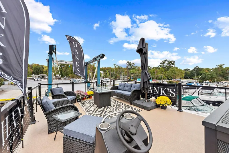  Yacht Photos Pics Rooftop deck of 2026 Custom Hanks 26 Houseboat with seating and scenic marina view.