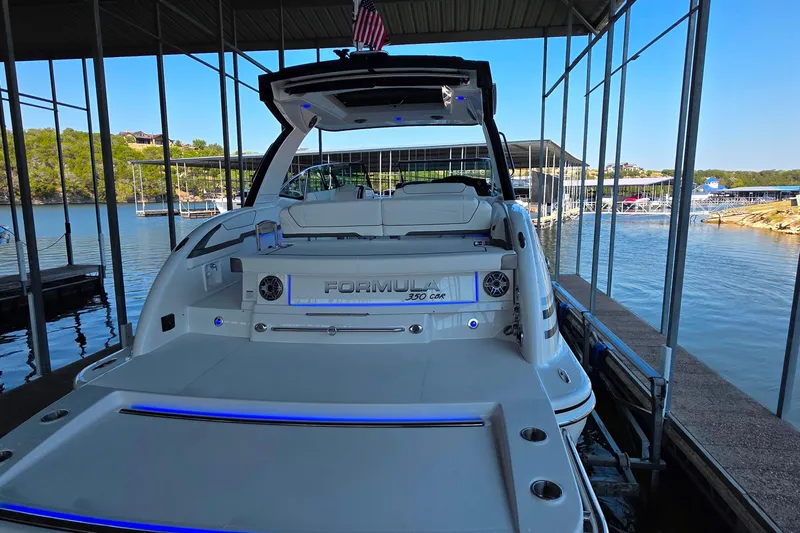  Yacht Photos Pics 2026 Formula 350 Crossover Bowrider I/O docked at a marina with scenic lake view.