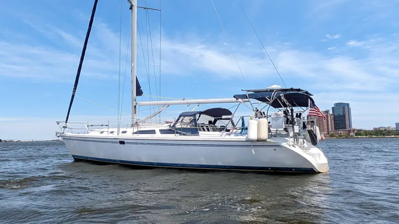  Yacht Photos Pics 2004 Catalina 42 MkII sailboat on water with city skyline in background.