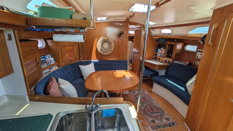  Yacht Photos Pics Interior of 2004 Catalina 42 MkII sailboat with cozy seating and wooden finishes.