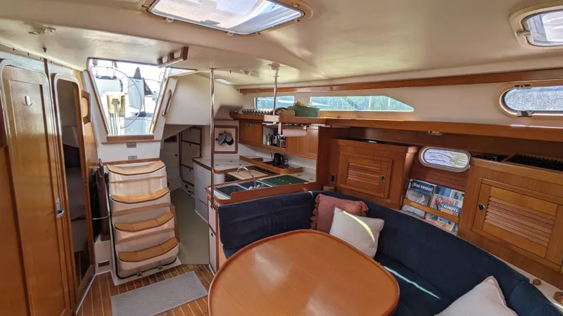  Yacht Photos Pics Interior of 2004 Catalina 42 MkII sailboat with cozy seating and wooden cabinetry.
