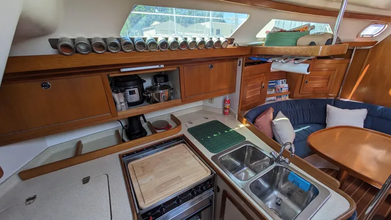  Yacht Photos Pics 2004 Catalina 42 MkII yacht interior with kitchen, dining area, and wooden cabinetry.