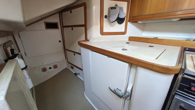  Yacht Photos Pics 2004 Catalina 42 MkII yacht interior kitchen with wooden cabinets and countertop.