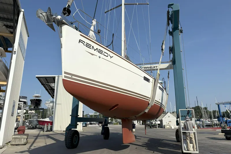 Remedy Yacht Photos Pics 2012 Jeanneau 57 sailboat "Remedy" lifted in a marina with blue sky background.
