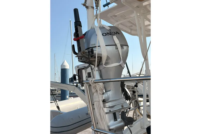 Remedy Yacht Photos Pics Outboard motor on a 2012 Jeanneau 57 sailboat, docked at a marina.