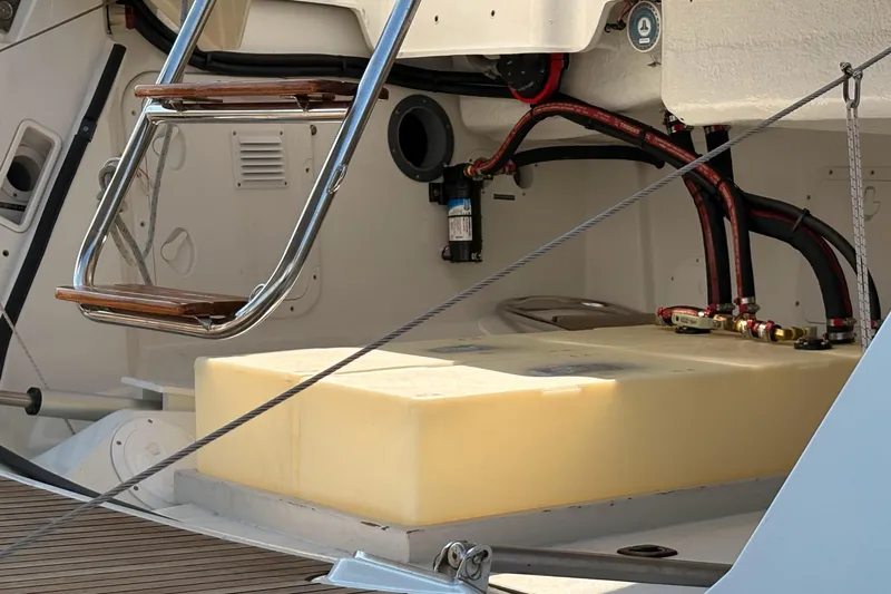 Remedy Yacht Photos Pics Engine compartment of a 2012 Jeanneau 57 yacht, featuring a ladder and fuel tank.