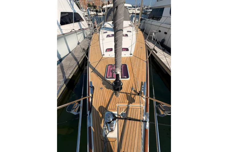 Remedy Yacht Photos Pics 2012 Jeanneau 57 sailboat with teak deck, docked at marina.