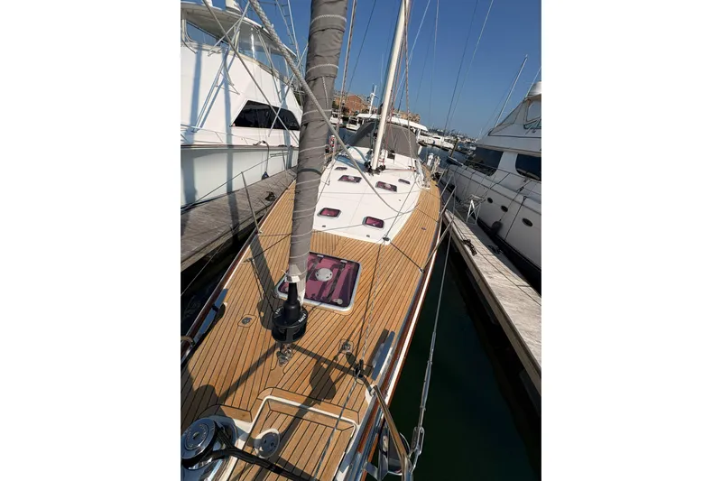 Remedy Yacht Photos Pics 2012 Jeanneau 57 sailboat docked, showcasing sleek wooden deck and rigging.