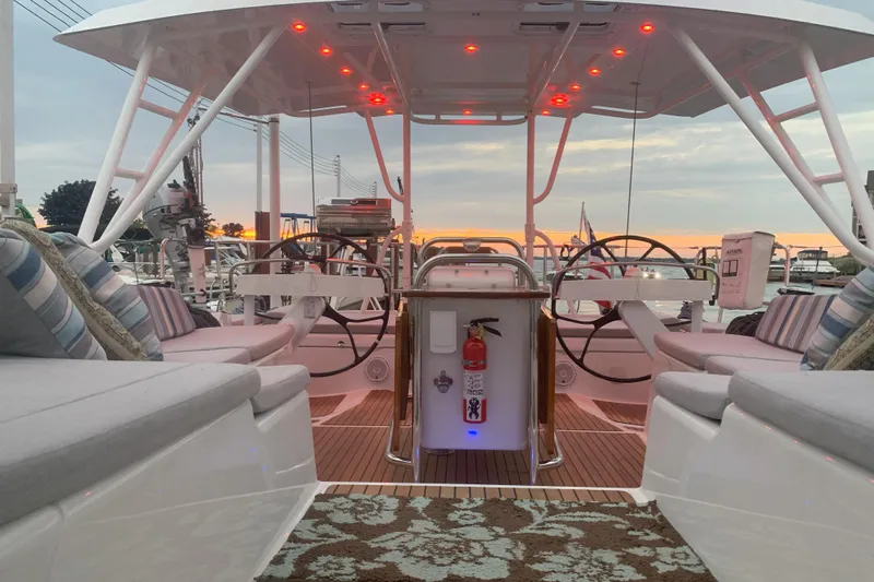 Remedy Yacht Photos Pics Luxurious 2012 Jeanneau 57 yacht interior with elegant seating and dual steering wheels at sunset.