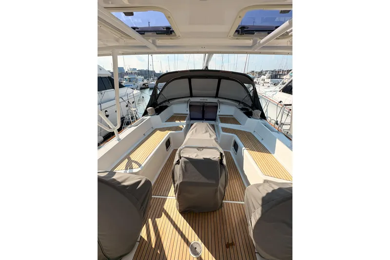Remedy Yacht Photos Pics 2012 Jeanneau 57 yacht cockpit with teak flooring and covered seating at marina.