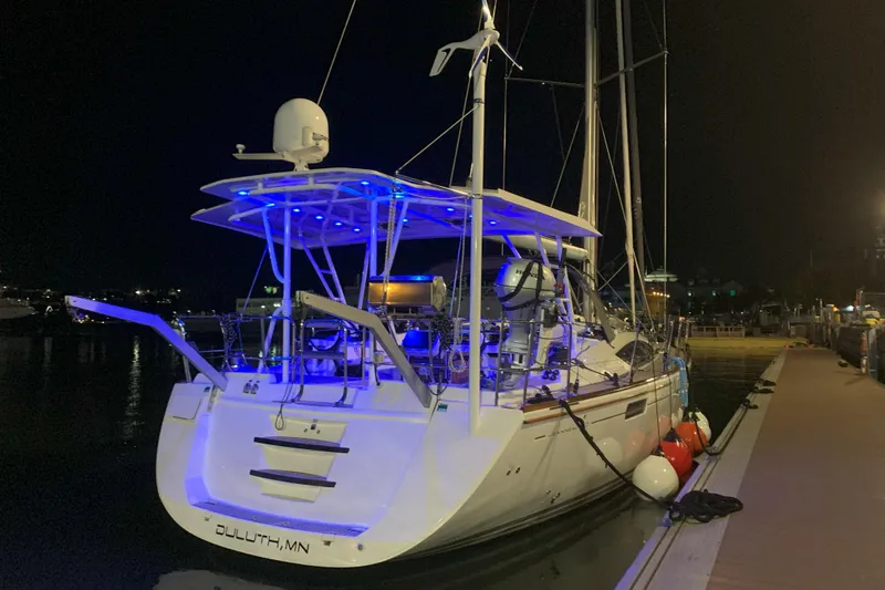 Remedy Yacht Photos Pics 2012 Jeanneau 57 yacht docked at night with blue deck lights.