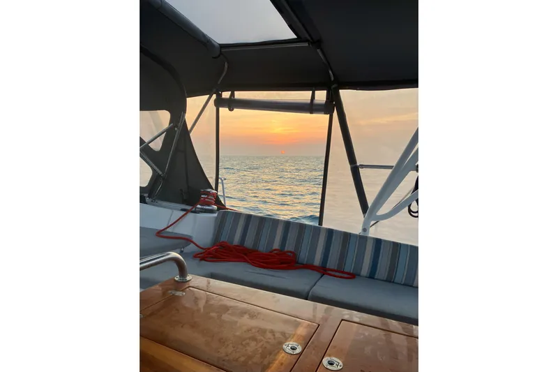 Remedy Yacht Photos Pics Jeanneau 57 sailboat cockpit with ocean sunset view, 2012 model.