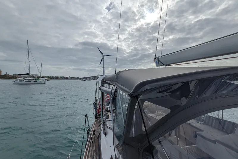 Remedy Yacht Photos Pics Sailing on a 2012 Jeanneau 57 yacht under cloudy skies, with other boats nearby.