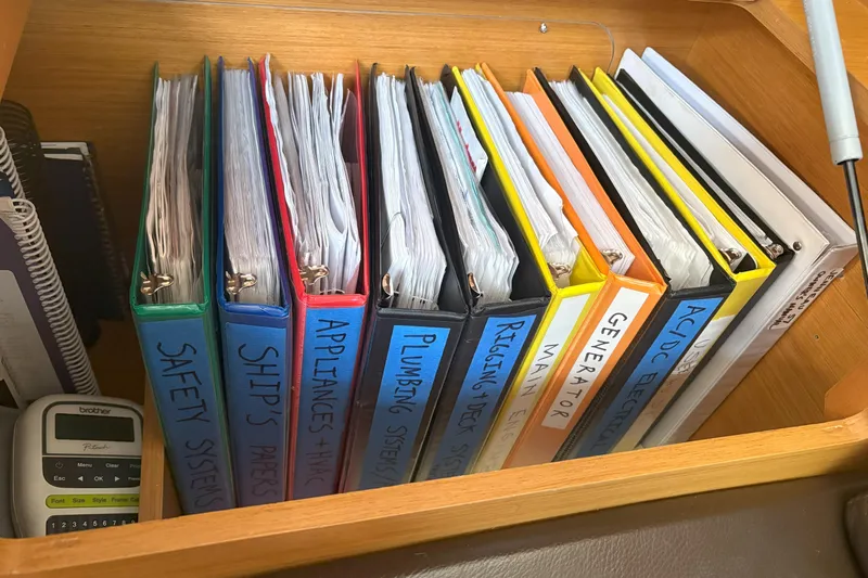 Remedy Yacht Photos Pics Binders with labels for safety, ship's papers, appliances, plumbing, and more on a Jeanneau 57 yacht.