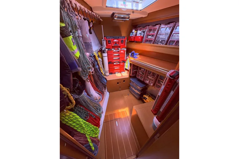 Remedy Yacht Photos Pics Storage area on a 2012 Jeanneau 57 yacht, organized with ropes and toolboxes.