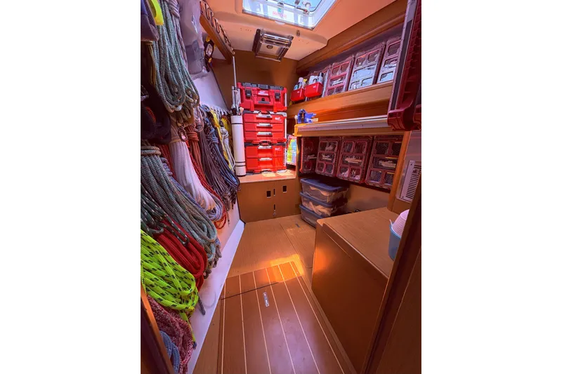 Remedy Yacht Photos Pics Interior of 2012 Jeanneau 57 yacht with organized ropes and storage compartments.