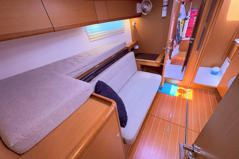 Remedy Yacht Photos Pics Interior of 2012 Jeanneau 57 yacht with cozy seating and wooden flooring.