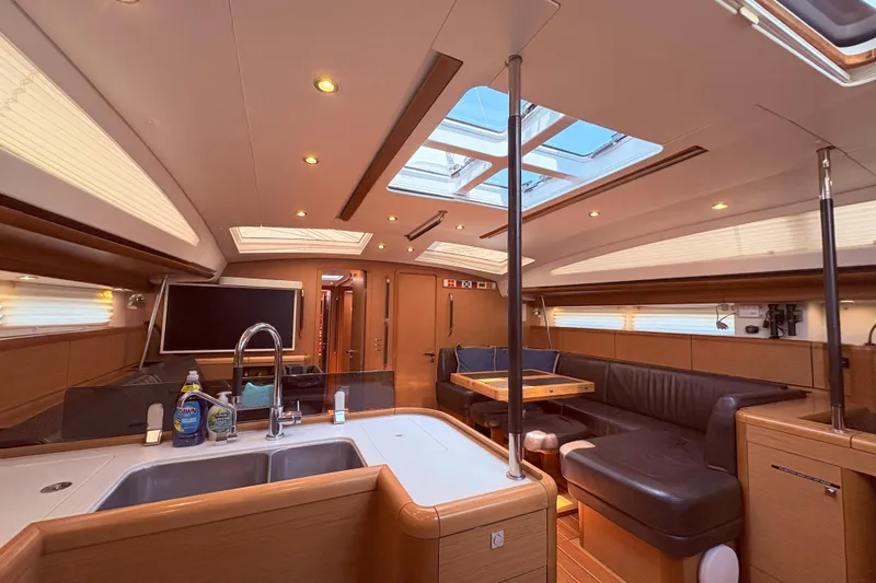 Remedy Yacht Photos Pics Luxurious interior of a 2012 Jeanneau 57 yacht with modern amenities and elegant design.