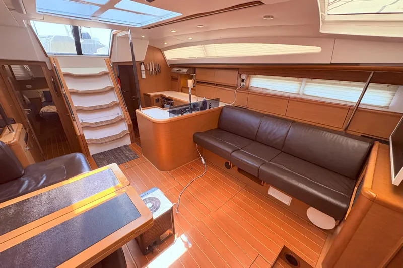 Remedy Yacht Photos Pics Luxurious interior of a 2012 Jeanneau 57 yacht with modern furnishings and ample natural light.