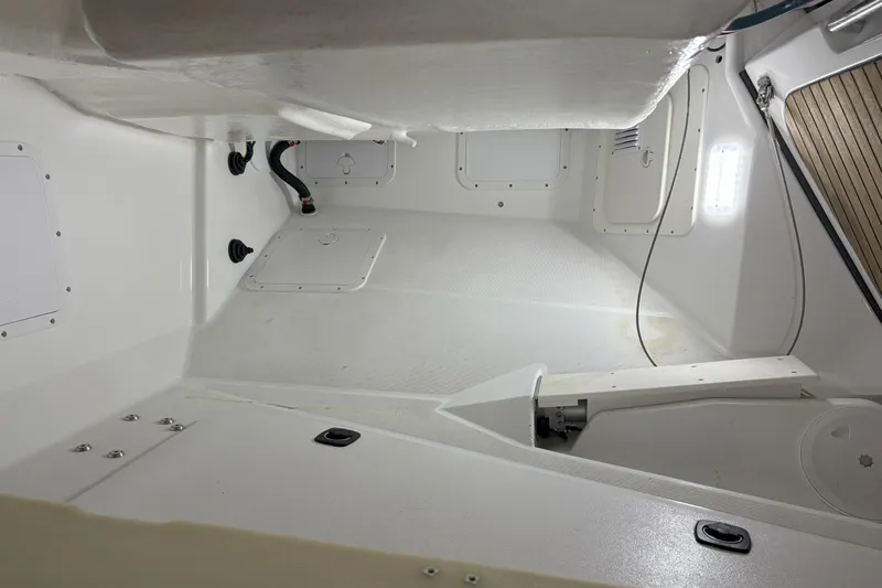 Remedy Yacht Photos Pics Interior view of a 2012 Jeanneau 57 sailboat, showcasing clean, white storage compartments.