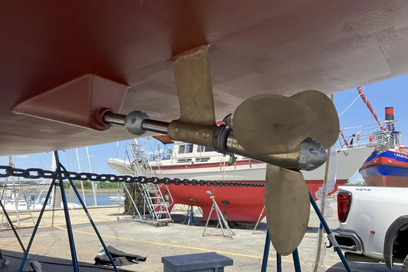 Remedy Yacht Photos Pics Propeller of 2012 Jeanneau 57 sailboat in dry dock, with other boats in background.