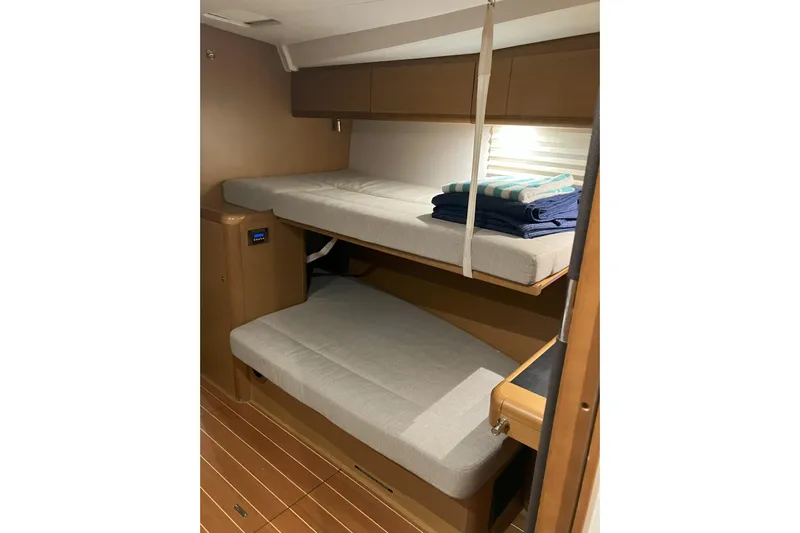 Remedy Yacht Photos Pics Interior of 2012 Jeanneau 57 yacht with cozy bunk beds and wooden finish.
