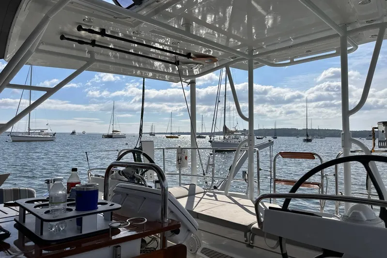 Remedy Yacht Photos Pics View from Jeanneau 57 yacht, overlooking a serene harbor with sailboats and blue sky.